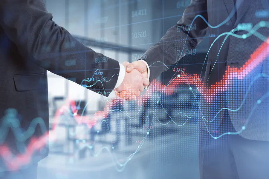 Apretón de manos entre profesionales con fondo de gráficos de crecimiento y análisis, simbolizando la gestión experta de cuentas Amazon y el aumento de ventas y rentabilidad.